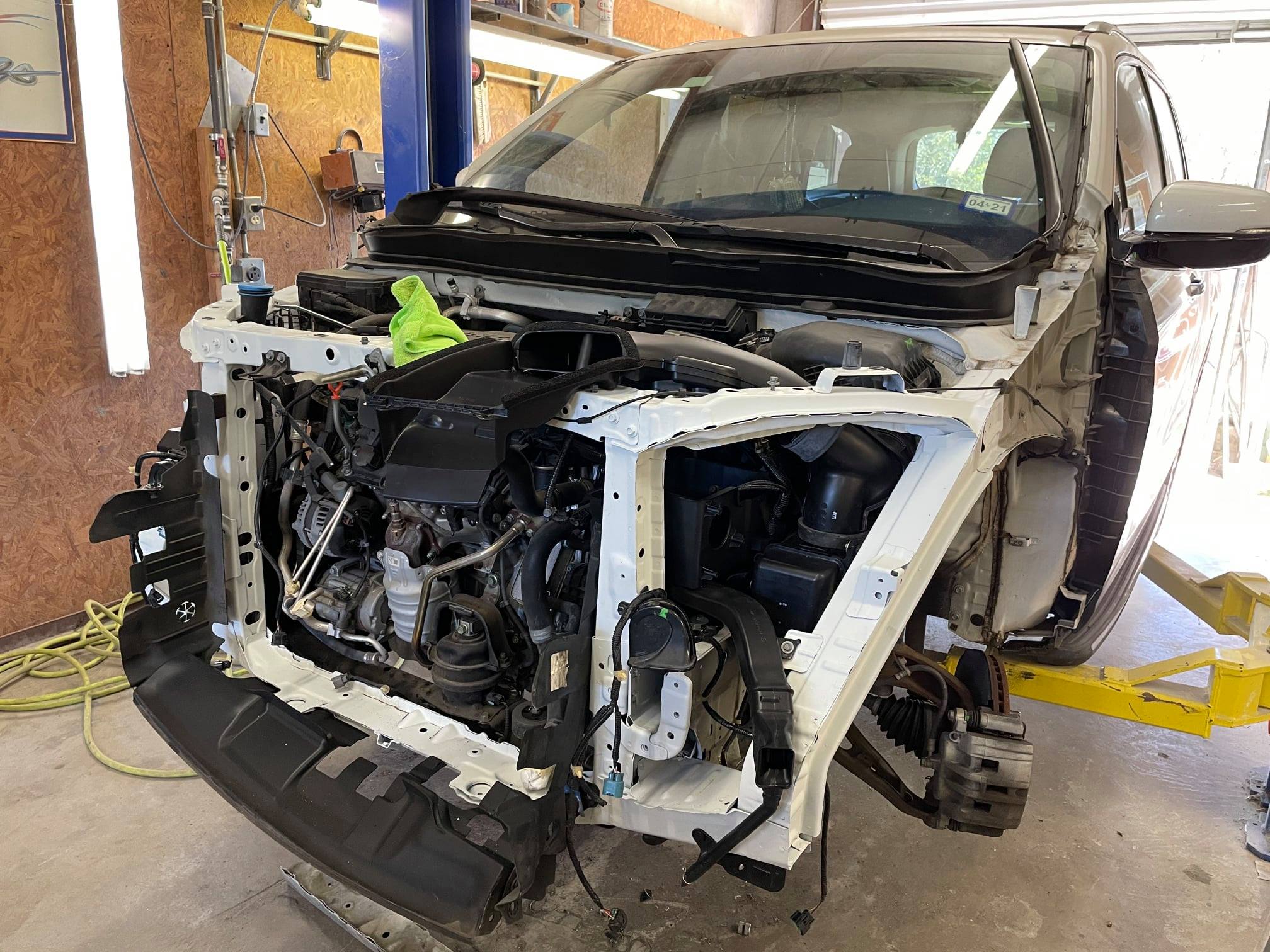 Honda Pilot mid-repair with panels removed at the body shop